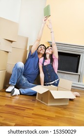 Young Couple Being Silly With Moving Boxes At Home