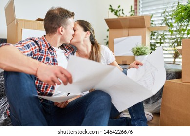 Young Couple With Blueprint Kissing In Love And Looking Forward To Their New Home