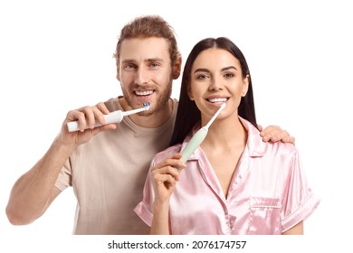 Young couple brushing teeth on white background - Powered by Shutterstock