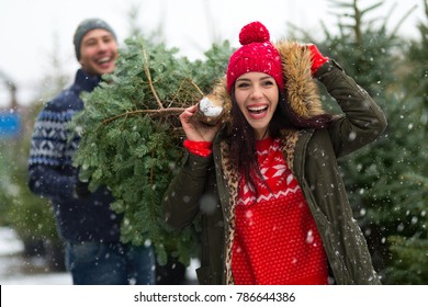 Young couple buying Christmas tree