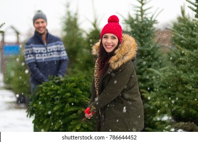 Young Couple Buying Christmas Tree