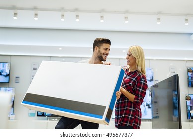 Young Couple Buying New 3D TV.