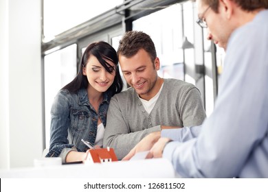Young couple buying new home. Meeting with architect.