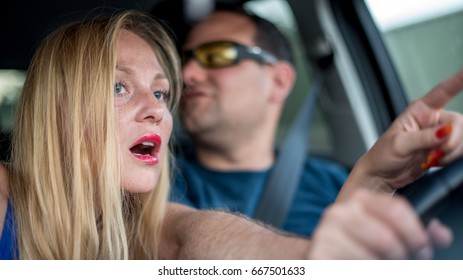 Young couple by car driving