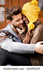 Young Couple In A Cabin In Romantic Scape In Winter