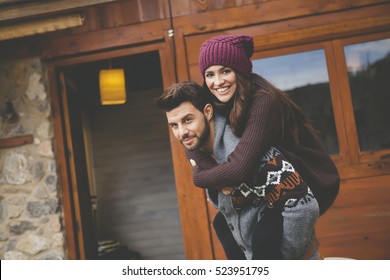 Young Couple In A Cabin In Romantic Scape In Winter