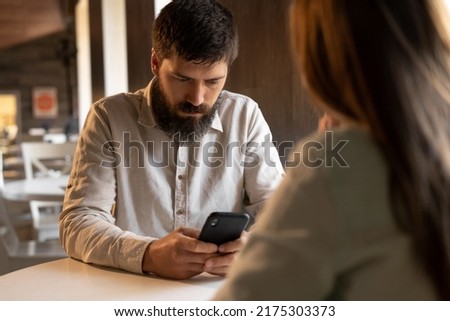 young couple in cafe, relationship problem, man in restaurant using phone and bored woman, family relationship crisis concept