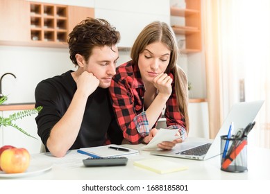 Young Couple Calculating Money At Home. Financial Revision, Home Budget Concept