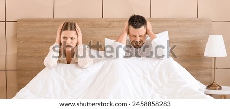 Young couple cannot sleep because of rowdy neighbours