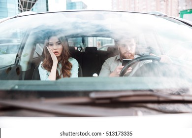 Young Couple In Car. Girl Is Not Happy