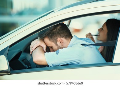 Young Couple In The Car. Love Concept. Young Man Is Waiting While Her Girlfried Doing Make Up. 