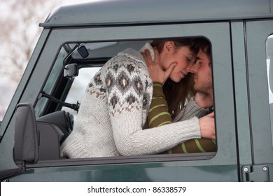 Young Couple In Car In Snow