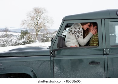 Young couple in car in snow