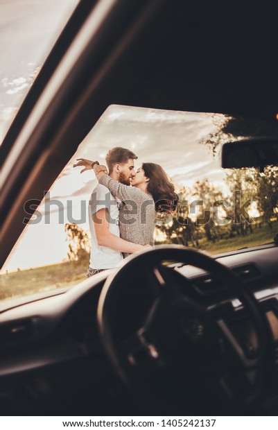 Young couple with car\
sunset