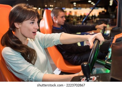 A Young Couple In Casual Clothes Playing Racing Game