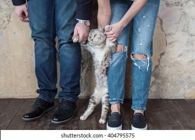 A Young Couple With A Cat