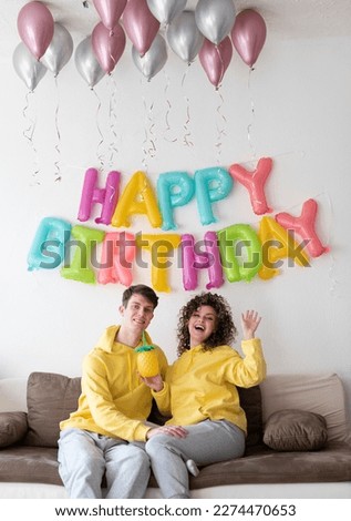 Similar – Young couple celebrating a party with their dog