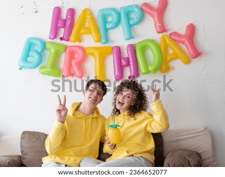 Similar – Young couple celebrating a party with their dog