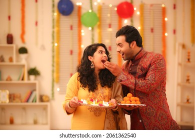 Young couple celebrating diwali with full of happiness - Shutterstock ID 2061362540