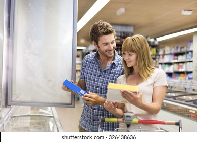 Young couple chooses frozen products in supermarket