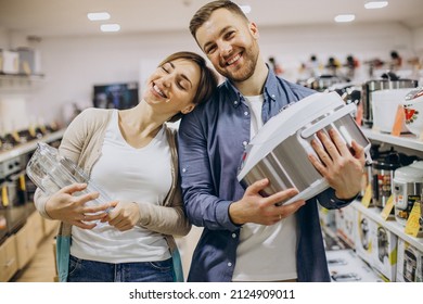 Young Couple Choosing Crockpot At Electric Store