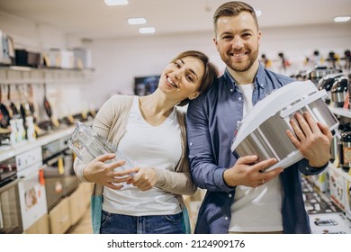 Young Couple Choosing Crockpot At Electric Store