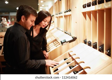 Young Couple Choosing Wine In A Store