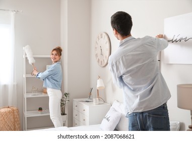 Young Couple Cleaning Their Bedroom