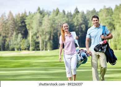 Young couple with clubs on the golf course - Powered by Shutterstock