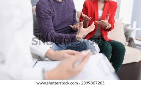 Young couple communicating with psychologist in office closeup. Family psychologist concept
