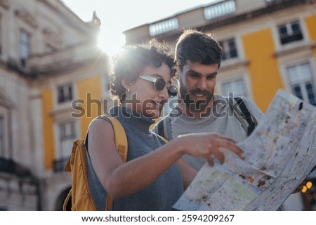Young couple consulting a map while exploring a charming european city during a sunny summer vacation, enjoying their adventure together