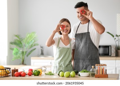 Young couple cooking in kitchen. Vegan Day - Powered by Shutterstock