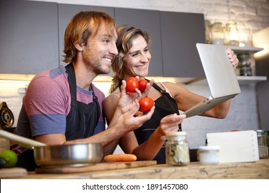 Young Couple Cooking And Sharing Online Cooking Tutorial