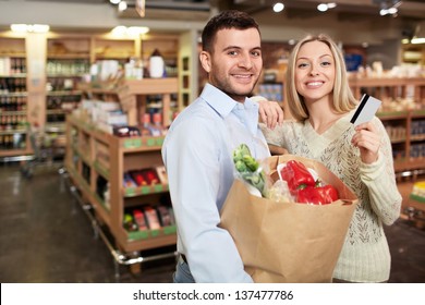 Young Couple With A Credit Card In A Store