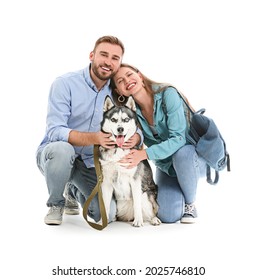 Young Couple With Cute Husky Dog On White Background