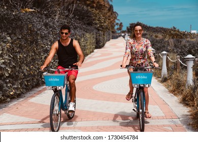 A Young Couple Cycling On A Sunny Day In Miami Beach, Florida, March 2020