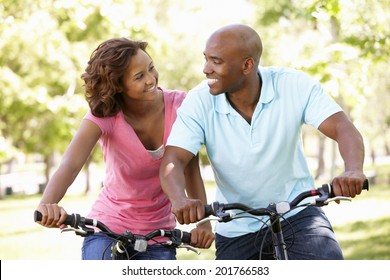 Young  Couple Cycling In Park