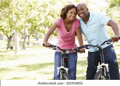 Young  Couple Cycling In Park