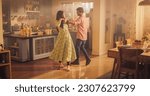 Young Couple Dancing and Having Fun in the Kitchen: Enjoying Each Other