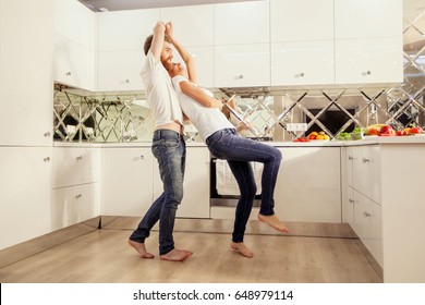 Young Couple Dancing In The Kitchen.