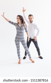 Young couple dancing latin dance bachata, merengue, salsa, kizomba. Two elegance pose over white background with copy space - Shutterstock ID 1511387816