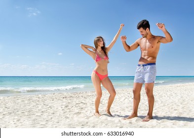 Young couple dancing on the beach