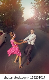 Young Couple Dancing On The Highway