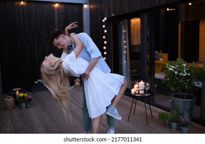 Young Couple Dancing Outdoors, Weekend Away In Tiny House In Countryside, Travel And Holiday Concept.