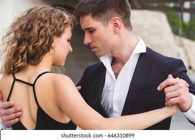 A Young Couple Dancing Tango Outside