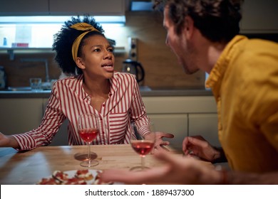 A Young Couple Discussing In A Tense Situation At The Kitchen. Dinner, Relationship, Together, Home