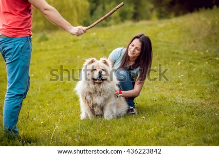 Young couple with the dogs in the park.