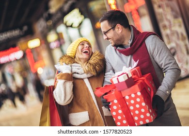 Young Couple Doing Christmas Shopping In The City