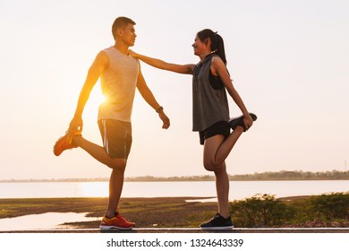 Young Couple Doing Exercises And Warm Up Before Run And Physical Fitness Test
