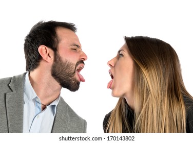 Young couple doing a joke over isolated white background 